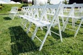 Rows of white folding chairs on lawn Royalty Free Stock Photo