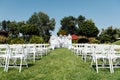 Rows of white folding chairs on lawn Royalty Free Stock Photo