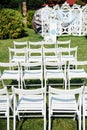 Rows of white folding chairs on lawn Royalty Free Stock Photo