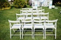 Rows of white folding chairs on lawn Royalty Free Stock Photo