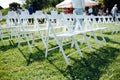 Rows of white folding chairs on lawn Royalty Free Stock Photo