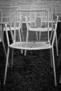 Rows of white metal garden chairs in front of an outdoor stage. Royalty Free Stock Photo