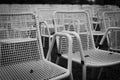 Rows of white metal garden chairs in front of an outdoor stage. Royalty Free Stock Photo