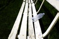 Rows of White Park Benches for Sitting on Green Grass Royalty Free Stock Photo