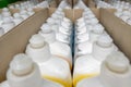 Rows of white plastic dishwasher liquid bottles.