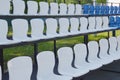Rows of white plastic empty stadium seats. Sports facility Royalty Free Stock Photo