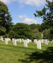 Rows of white tombstones down a hillside at Arlington National Cemetery in Arlington, Virginia