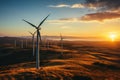 Rows of wind turbines generating power in scenic evening scenery on summer. Windmills generating green energy on background of Royalty Free Stock Photo