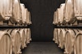 Rows of wine or beer kegs in black brick cellar