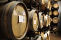 Rows of wine-filled cask barrels at a winery cellar. Royalty Free Stock Photo