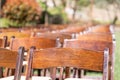 Rows of Wooden Event Chairs Outdoors at Wedding Venue Abstract Royalty Free Stock Photo