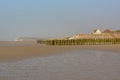 Rows of wooden poles for the cultivation of bouchot mussels and village of Wissant behind