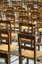 Rows of worn chairs in a church