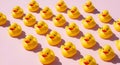 Rows of yellow rubber ducks on pink background toys Royalty Free Stock Photo