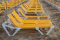 Rows of yellow sunbeds at the beach Playa de Puerto Rico on the Canary Island