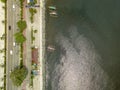 Roxas Boulevard and boardwalk. Top view of Manila Bay. A few outrigger boats moored on the breakwater