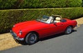 Classic Red MG Open Top Sports Car Parked by hedge. Royalty Free Stock Photo