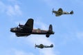 Royal Air Force RAF Battle Of Britain Memorial Flight Avro Lancaster bomber PA474 flying in formation with Supermarine Spitfires Royalty Free Stock Photo