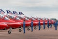 Royal Air Force RAF Red Arrows ground crew members give directions to the pilots in their British Aerospace Hawk T.1 jet trainer