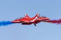 Royal Air Force Red Arrows display team opposition pair crossing at airshow