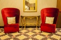 Royal Armchair in red in warm athmosphere decoration Royalty Free Stock Photo