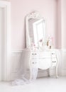 Royal bedroom. Place for make-up girls. Elegant white dressing table with mirror in light classic luxury interior.