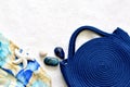 Royal blue knitted beach handbag with floral scarf background Royalty Free Stock Photo