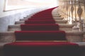 Marble stairways covered with red carpet