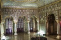 Royal City Palace Jaipur interior view of glass room with mirror and gold artwork at Rajasthan, India Royalty Free Stock Photo
