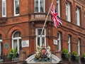 royal coat of arms appears in a patriotic display above an expensive shop in Mayfair Royalty Free Stock Photo