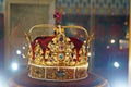 The royal crown made of gold and decorated with multi-colored precious stones