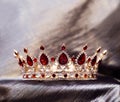 Royal crown with red stones, garnet, crystals. Royalty Free Stock Photo