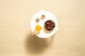 Royal dates fruit in a bowl of coconut, sunglasses, orange juice on the white table on the sandy beach. Summer vacation. Top view. Royalty Free Stock Photo