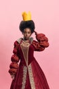 Royal Elegance. Portrait of young, beautiful african woman, medieval princess in vintage dress holding paper crown