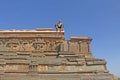 Royal enclosure in Hampi. A bald tourist man sits upstairs and l