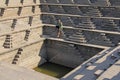 Royal enclosure in Hampi. A young bald man is sitting on the ste Royalty Free Stock Photo