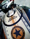 A Royal Enfield bike parked in front yard of a Indian house.