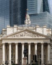 The Royal Exchange facade in front of modern glass skyscrapers