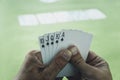 playing cards in a man& x27;s hand on the background of a casino gaming table. Royal flush is best winning combination in Royalty Free Stock Photo