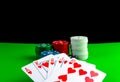 Royal flush cards and poker chips in stacks on a green table Royalty Free Stock Photo