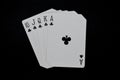 Royal Flush of clubs in poker authentic casino cards game on a black background