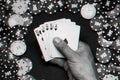 Royal flush in the game of poker in the hands of the player on the background of a green table with gaming chips Royalty Free Stock Photo