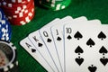 Royal flush in poker game. cards with casino chips on green cloth Royalty Free Stock Photo