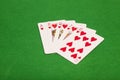 Royal flush poker playing cards on green felt background Royalty Free Stock Photo