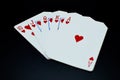 Royal flush straight flush of hearts cards in poker game against black background Royalty Free Stock Photo