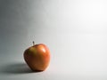 Royal Gala apple with its shadow on the left, Between Black and White light contrast Royalty Free Stock Photo