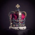 Royal golden crown with jewels on pillow on black background. Symbols of UK United Kingdom monarchy Royalty Free Stock Photo