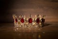 Royal golden crown with ruby, garnet gemstones, qrystals