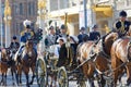 The royal guards sitting on horses protect the swedish royal family sitting in thr royal coach