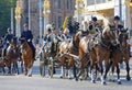 The royal guards sitting on horses protect the swedish royal family sitting in thr royal coach